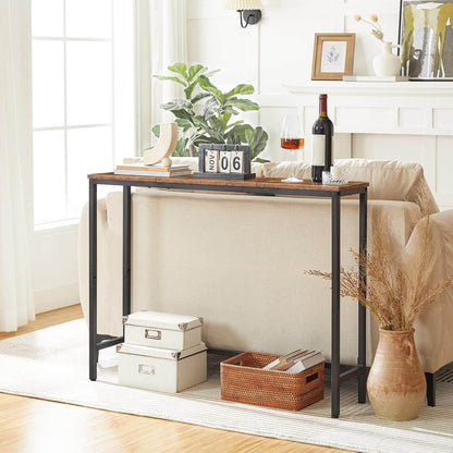 Skinny sofa table placed behind a living room couch holding plants and home decors