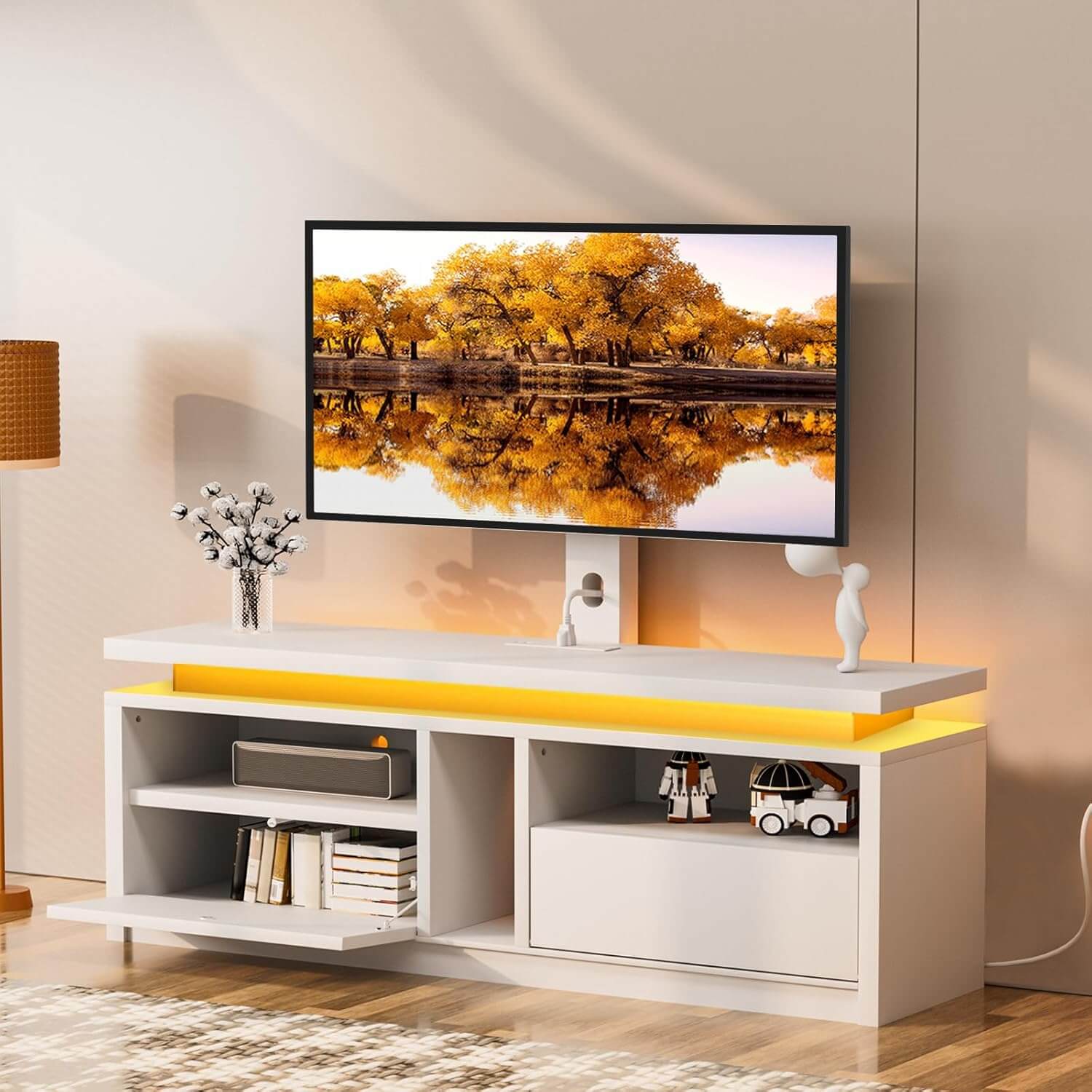 Modern TV stand with a television displaying a scenic view of trees and water.
