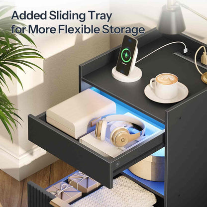 Nightstand with added sliding tray for flexible storage, featuring a phone, coffee cup, and other items.