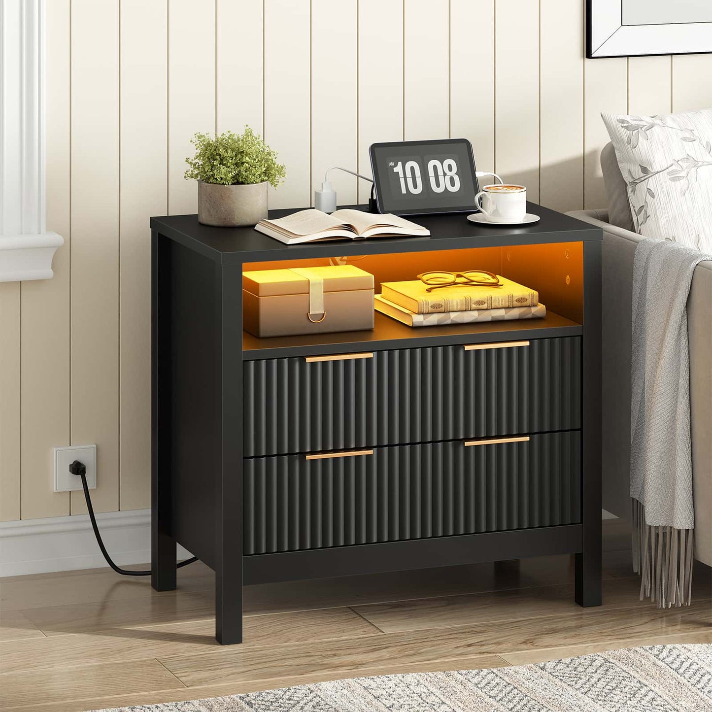 Black nightstand with illuminated interior in a bedroom setting