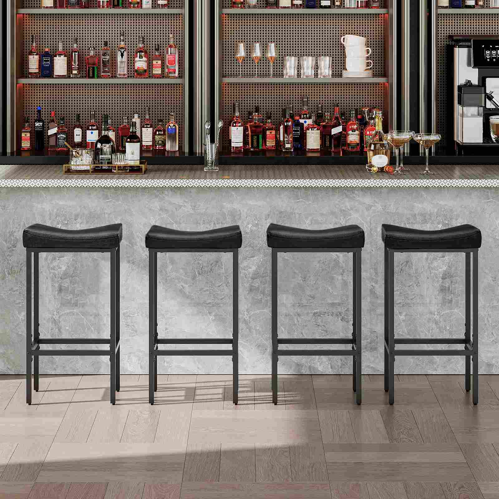 Front view of four black saddle bar stools placed neatly at a long commercial pub counter.