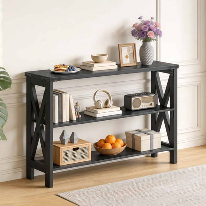 Black wood skinny hallway table styled beautifully with books and decor, standing against a cream-colored living room wall.