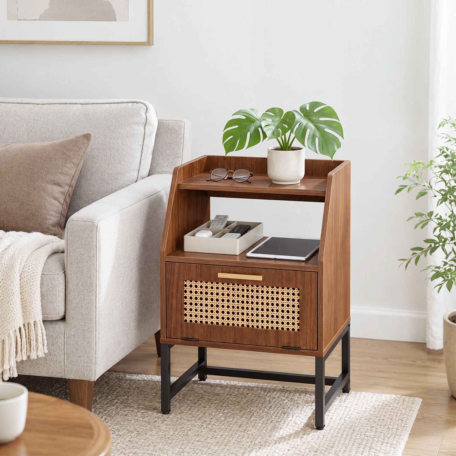 Rustic brown boho rattan side table placed next to a living room couch holding a green plant.