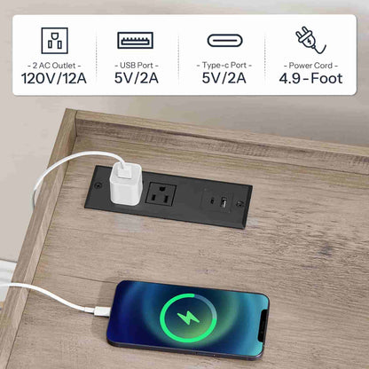 Close-up of the integrated desktop power strip with standard AC outlets and fast-charging USB ports.