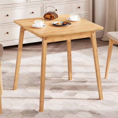  Compact natural bamboo wooden table set up for breakfast in a modern apartment dining corner.