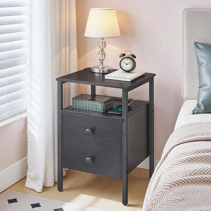 Compact bedroom nightstand with an open storage shelf and lamp shining on the tabletop.