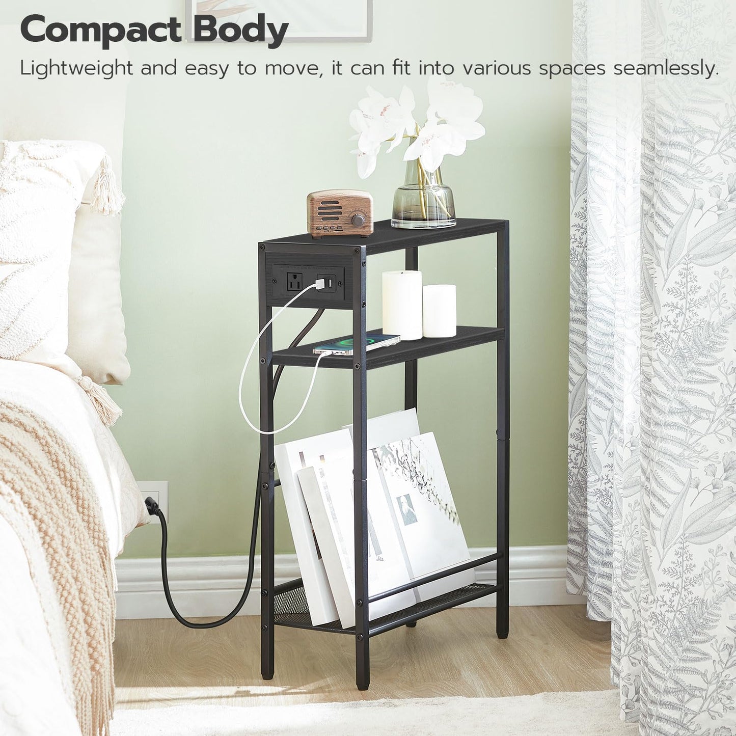 Compact all-black bedside nightstand standing stably inside a very narrow wall corner next to a double bed.
