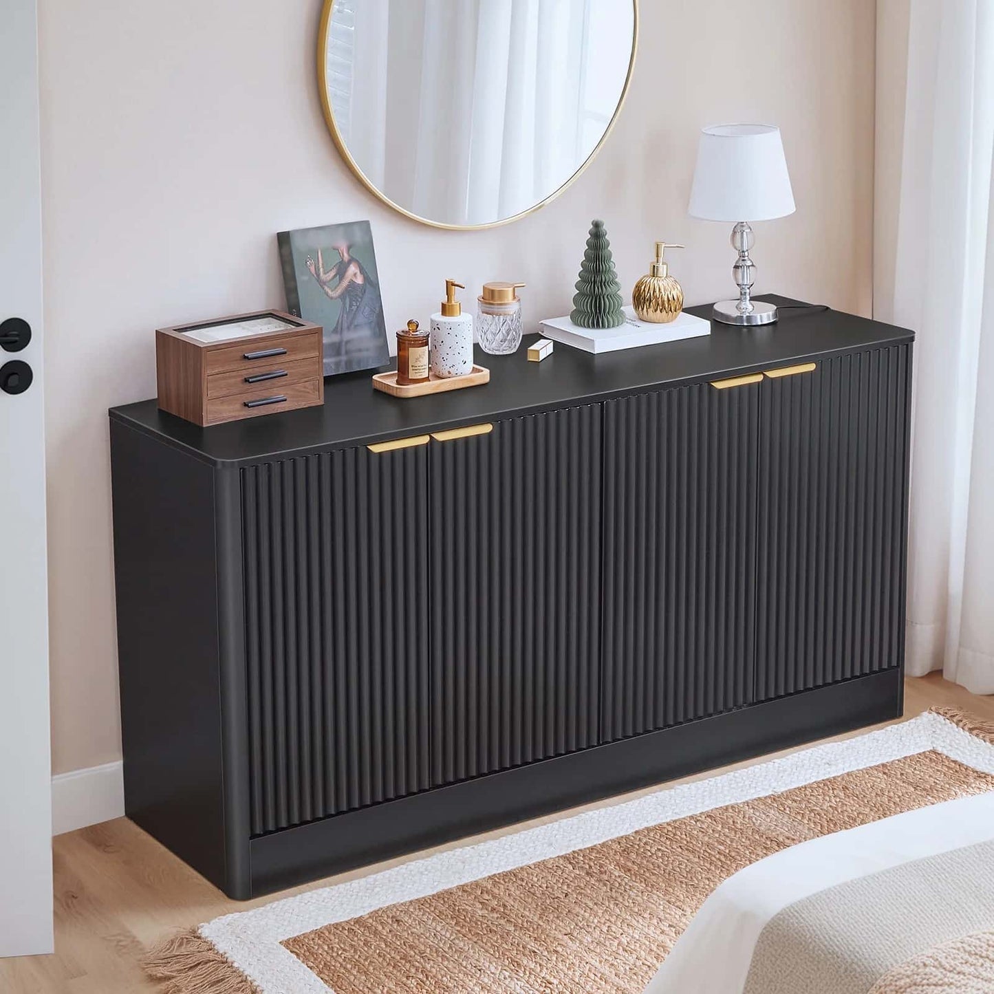 Black sideboard with decorative items in a room setting