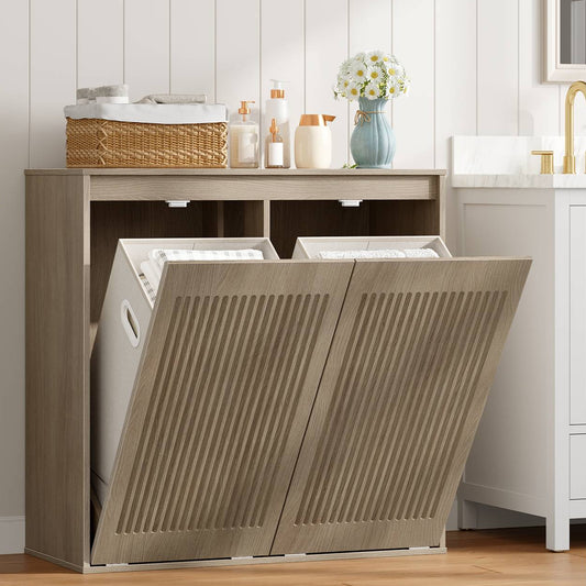 Greige double tilt-out laundry hamper cabinet styled in a modern bathroom holding baskets and towels.