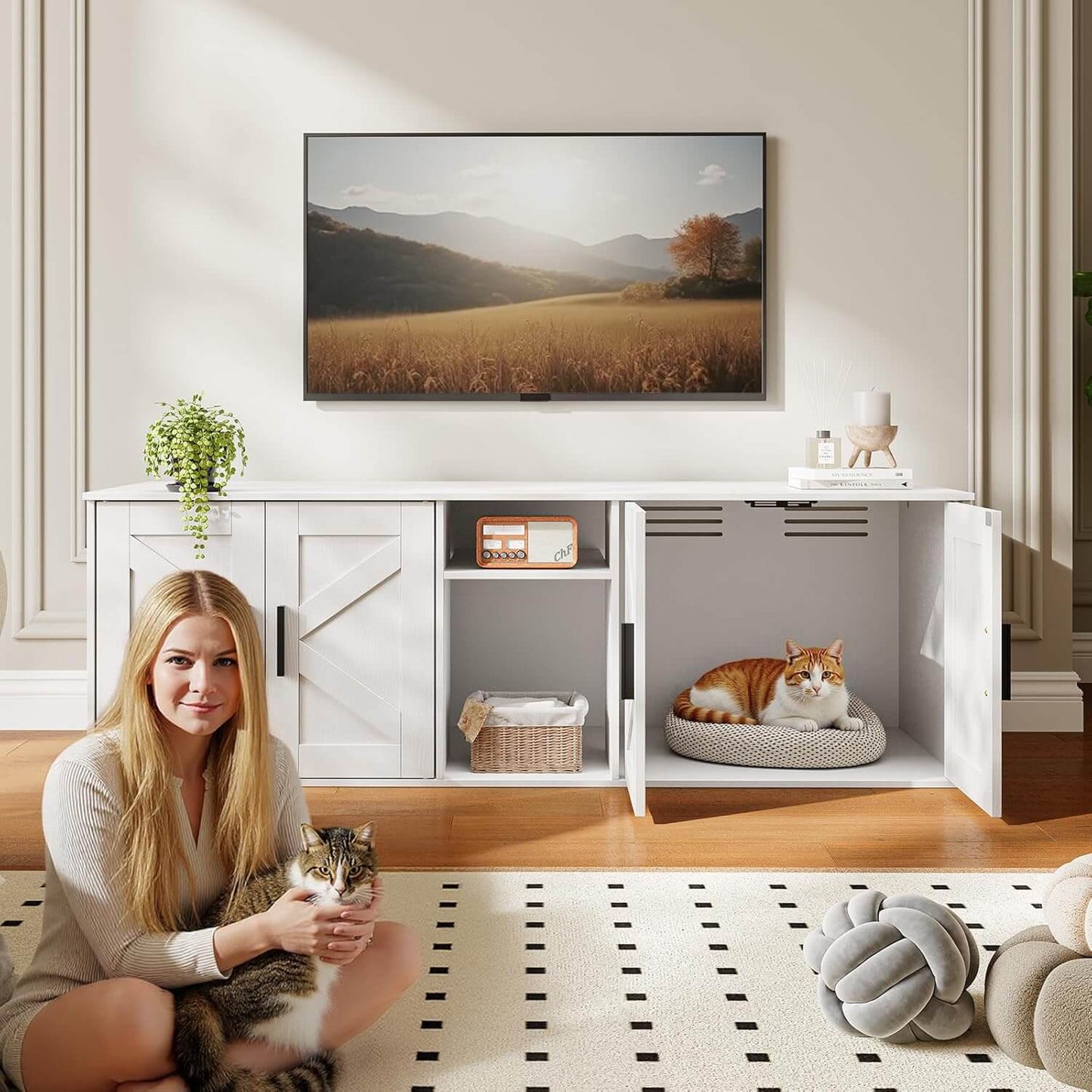 Woman holding a cat in a modern living room with a TV displaying a scenic landscape.