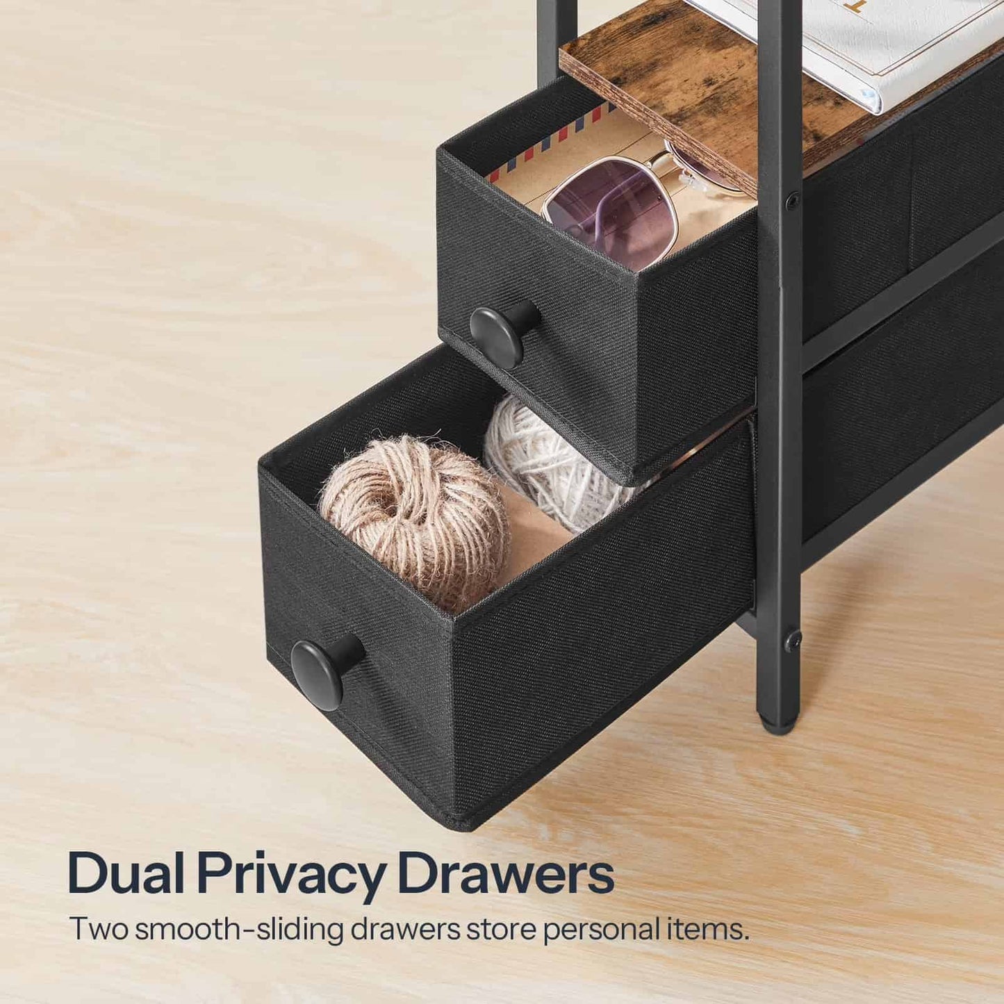 Close-up of the two black fabric collapsible drawers with handles at the bottom of the slim side table.