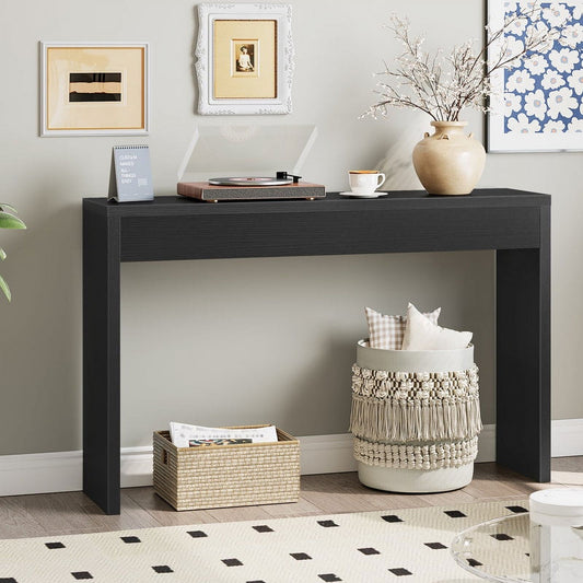 Black console table with decorative items in a living room setting