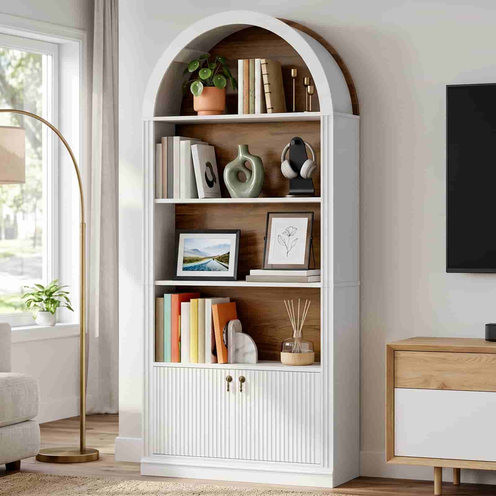 White arched display bookshelf with a warm light glow placed next to a modern TV stand setup.