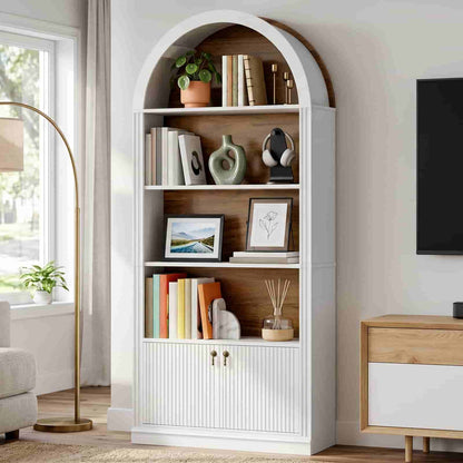 White arched display bookshelf with a warm light glow placed next to a modern TV stand setup.