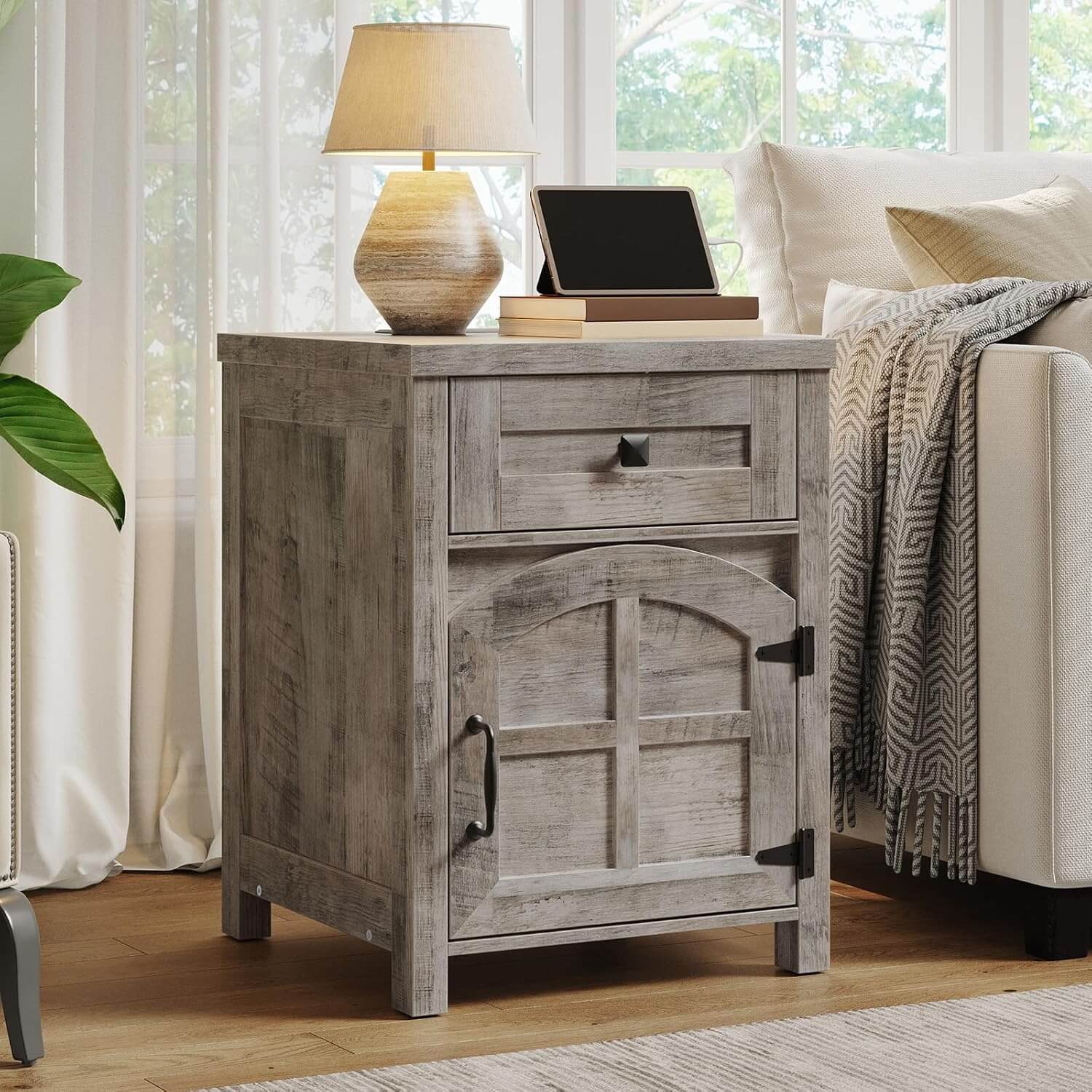 Wooden nightstand with lamp and tablet in a home setting