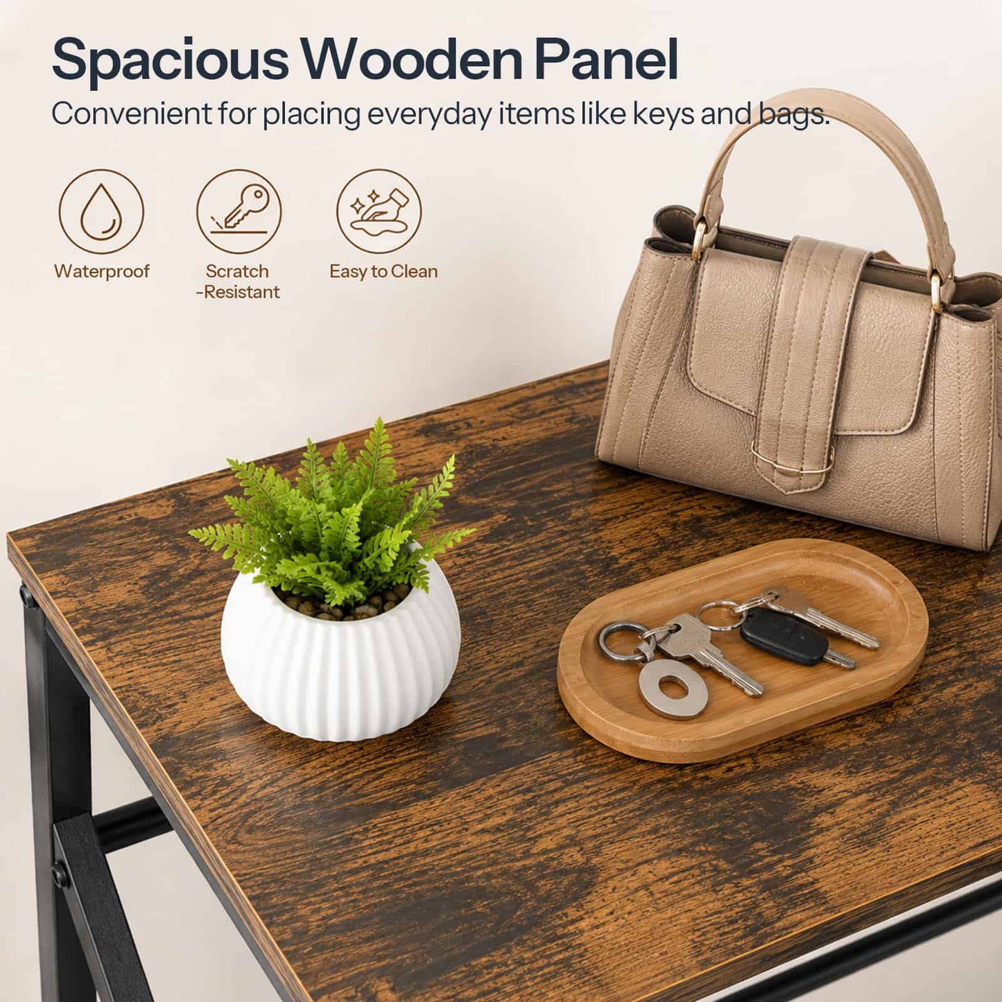 Close-up of the spacious wooden top panel holding a handbag, keys on a tray, and a mini potted plant.