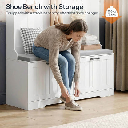 Woman sitting on a white shoe bench with storage, tying her shoes.