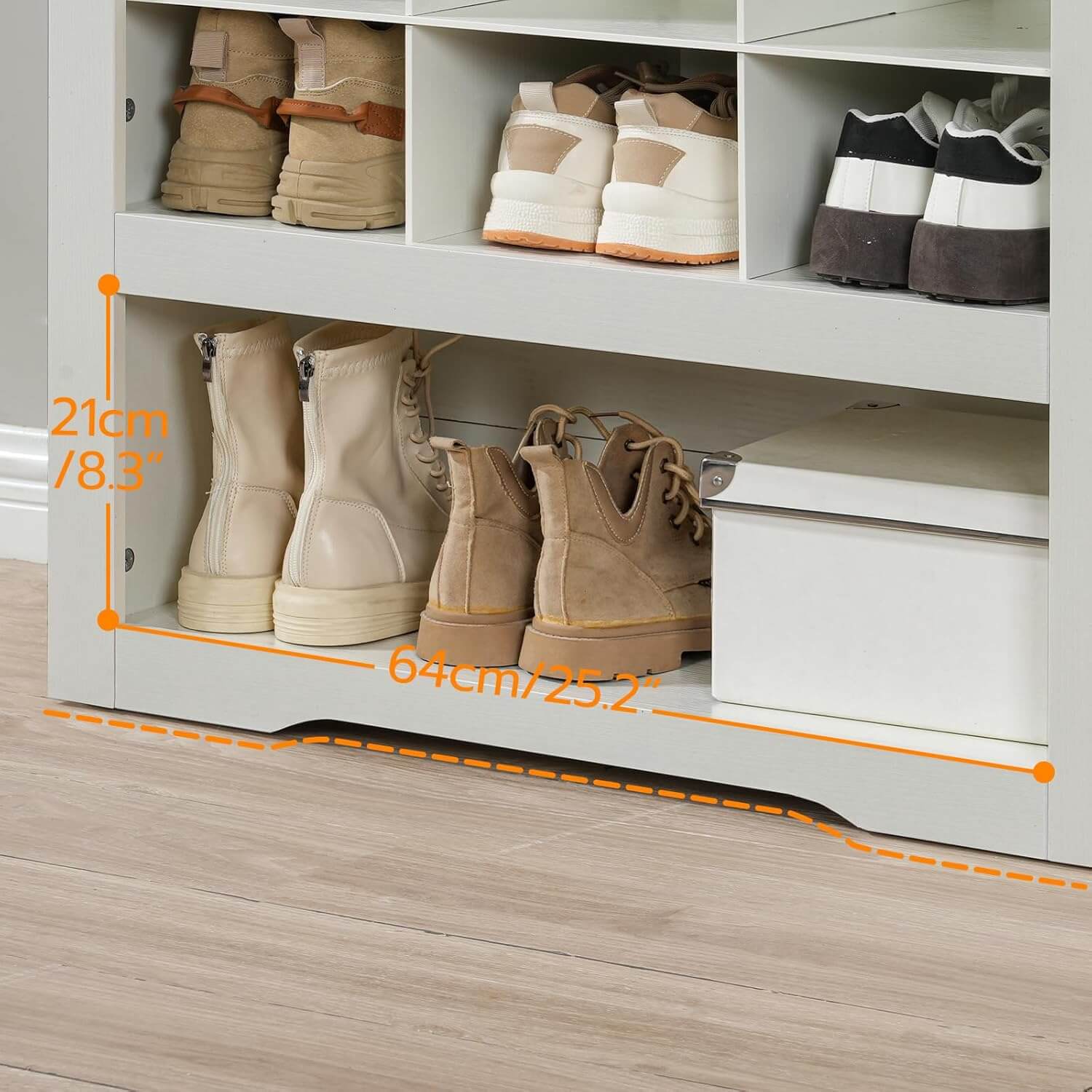 Close-up of the extra-large bottom shelf storing tall winter boots and a white organization box.