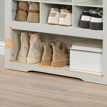 Close-up of the extra-large bottom shelf storing tall winter boots and a white organization box.