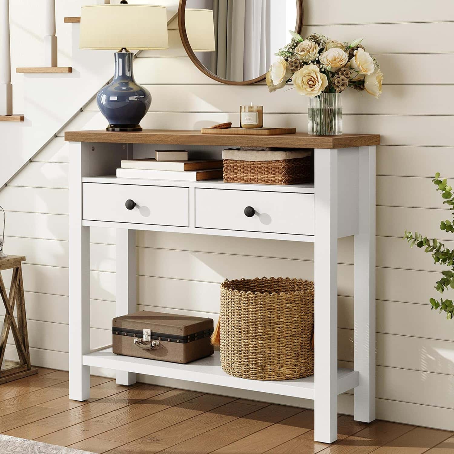 White console table with wooden top against a white paneled wall.