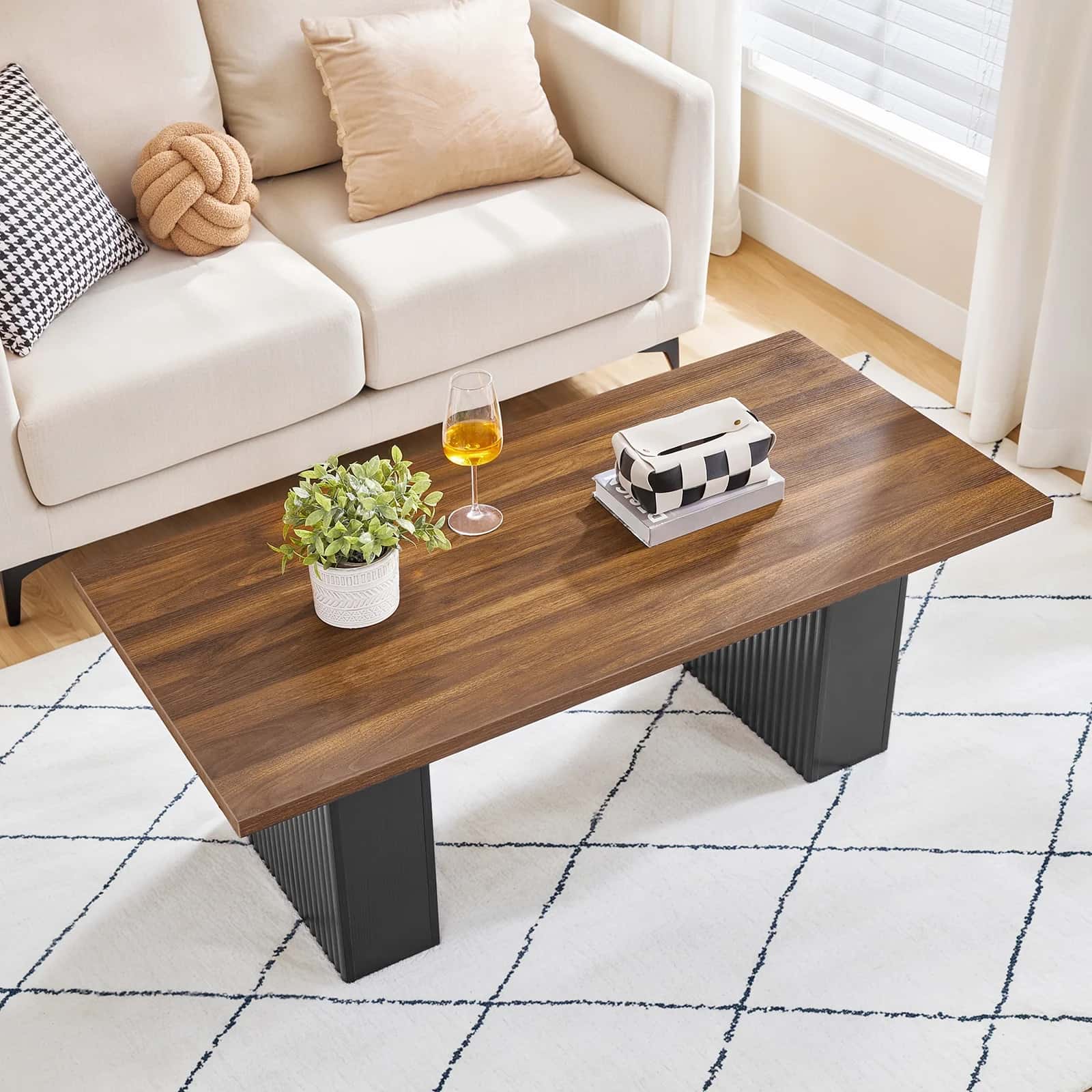 Wooden coffee table with decorative items in a living room setting