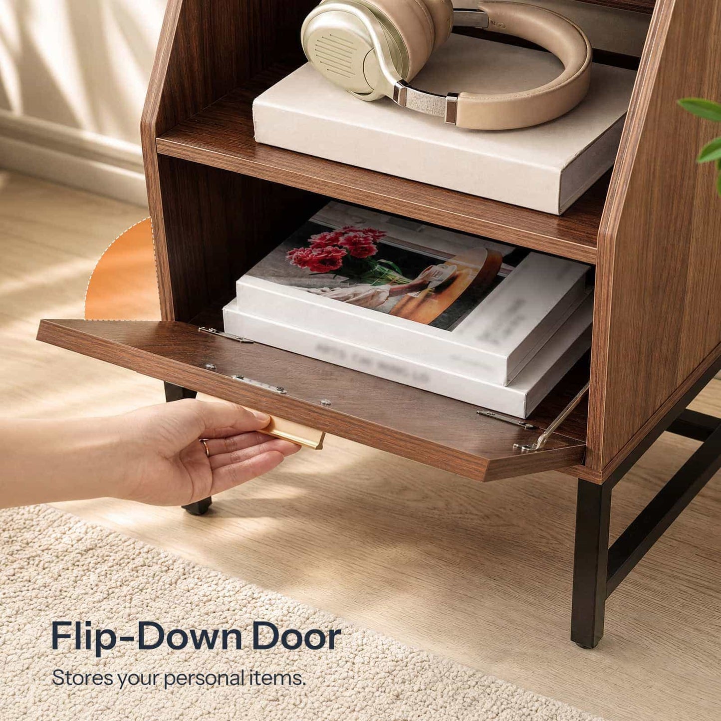 Close-up showing a hand pulling open the flip-down cabinet door featuring a sleek gold handle.