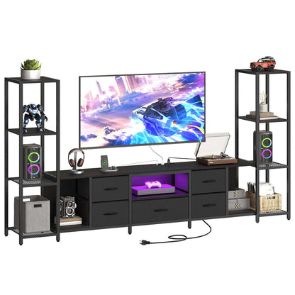 A modern black metal 7-piece TV stand and shelving unit set, shown with a television, speakers, headphones, and various decorative items on a plain white background.
