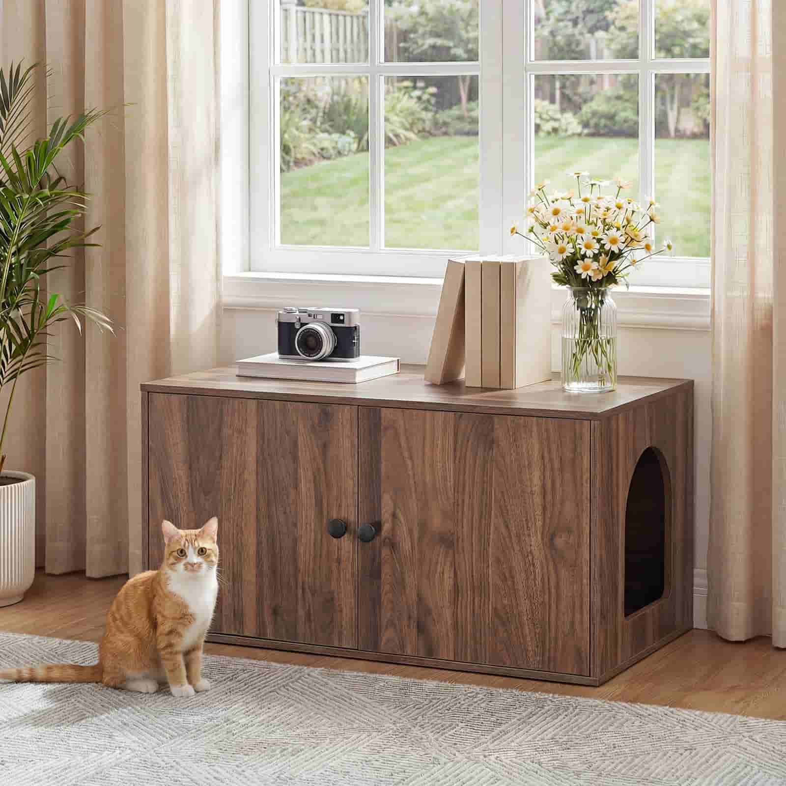 Walnut wood hidden cat litter box enclosure furniture styled as a bench near a window with a cat sitting nearby.