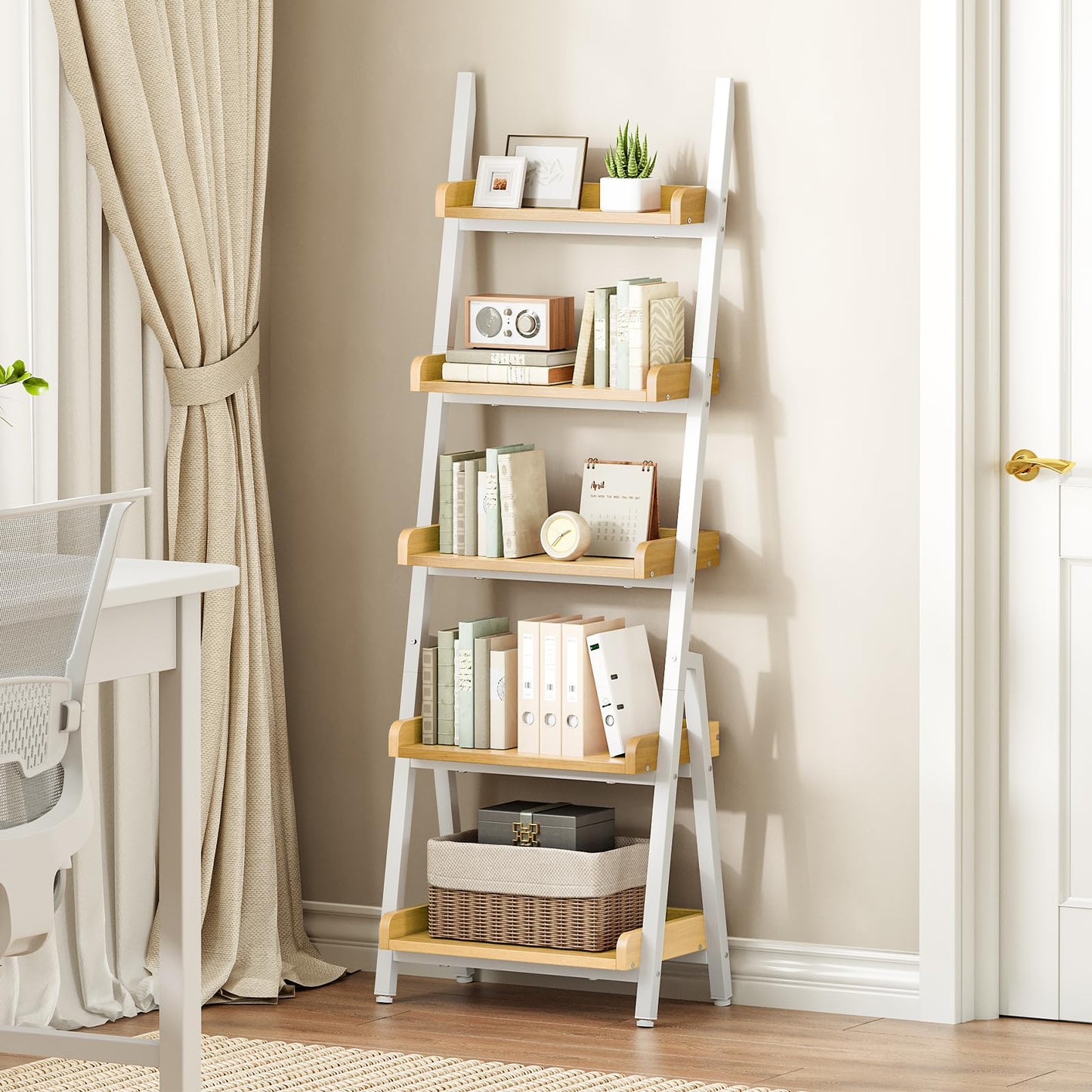 Ladder shelf with books and decor items against a beige wall.