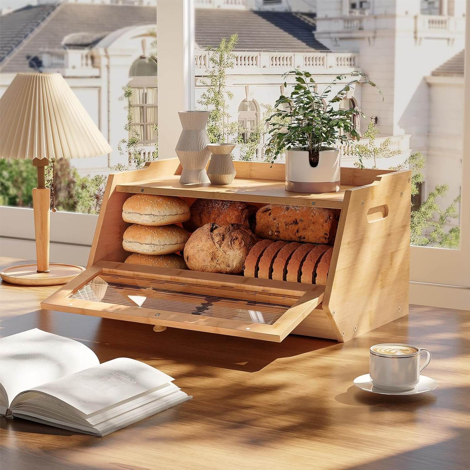 Wooden bread box with bread on a wooden table with a book and cup of coffee.