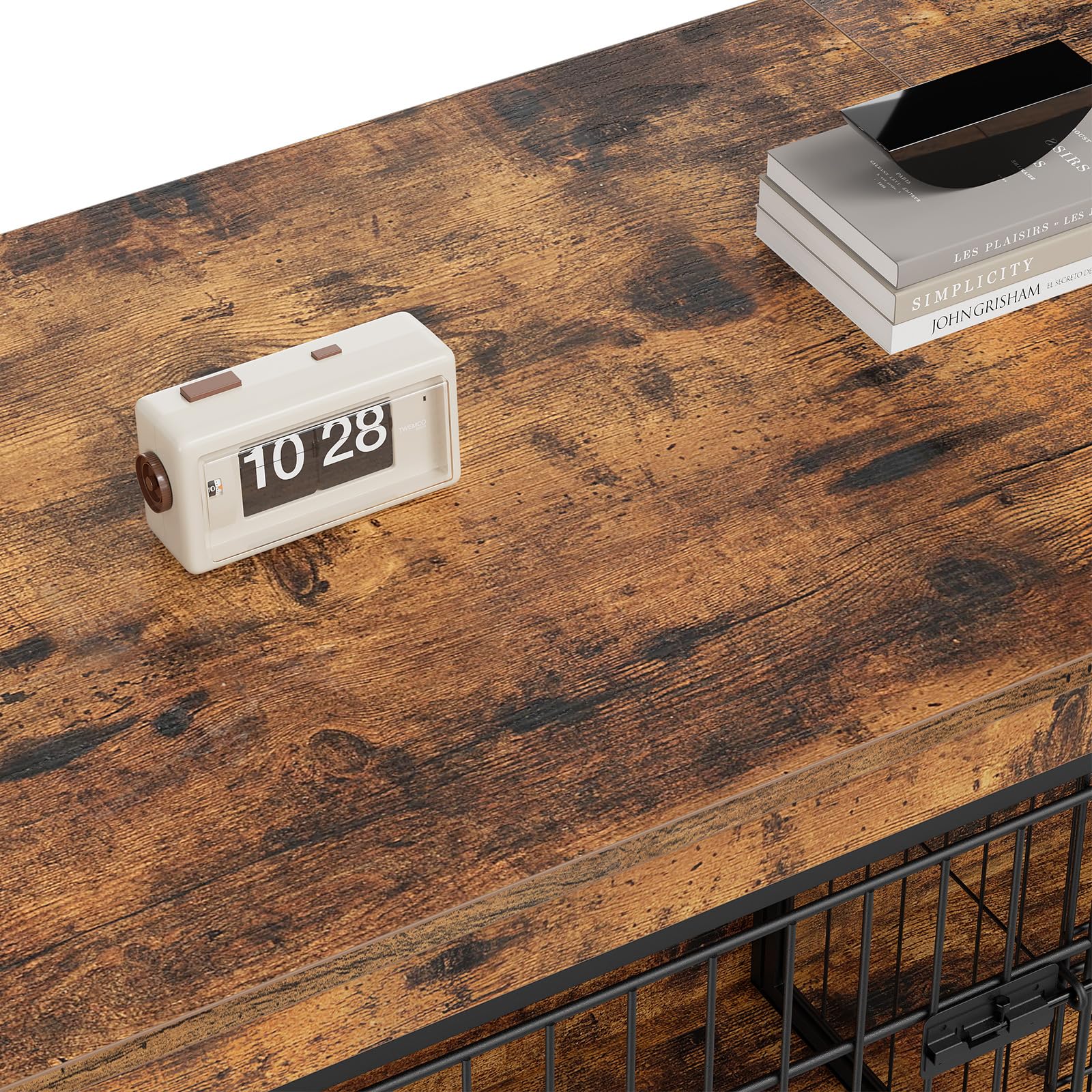 White flip clock on a wooden surface with a black metal basket and books in the background.