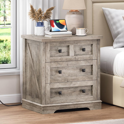 HOOBRO farmhouse greige nightstand with a hidden charging station standing next to a bed holding a tablet.