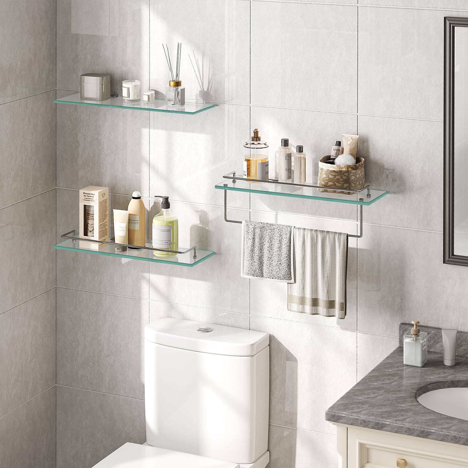 Bathroom with glass shelves, toiletries, and towels on a tiled wall.