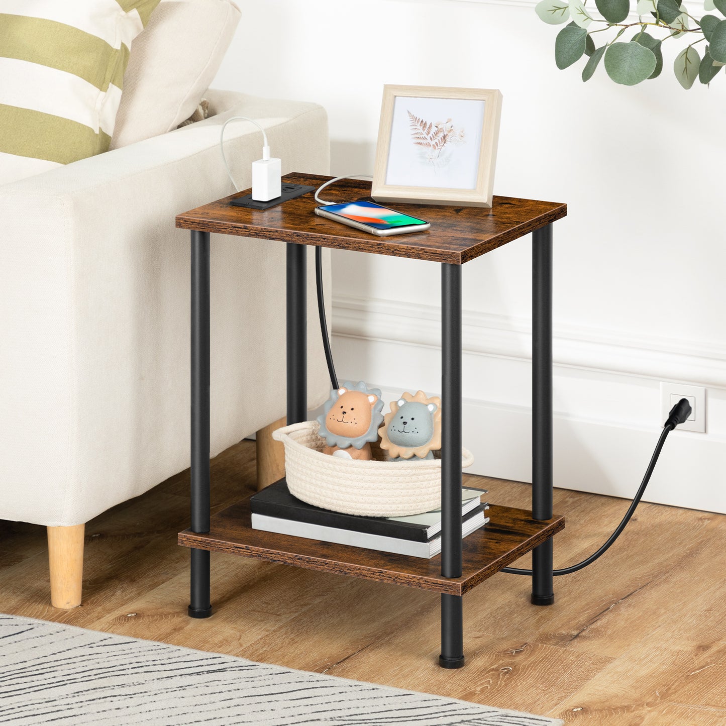 HOOBRO industrial nightstand with a built-in charging station standing next to a white sofa holding a smartphone.