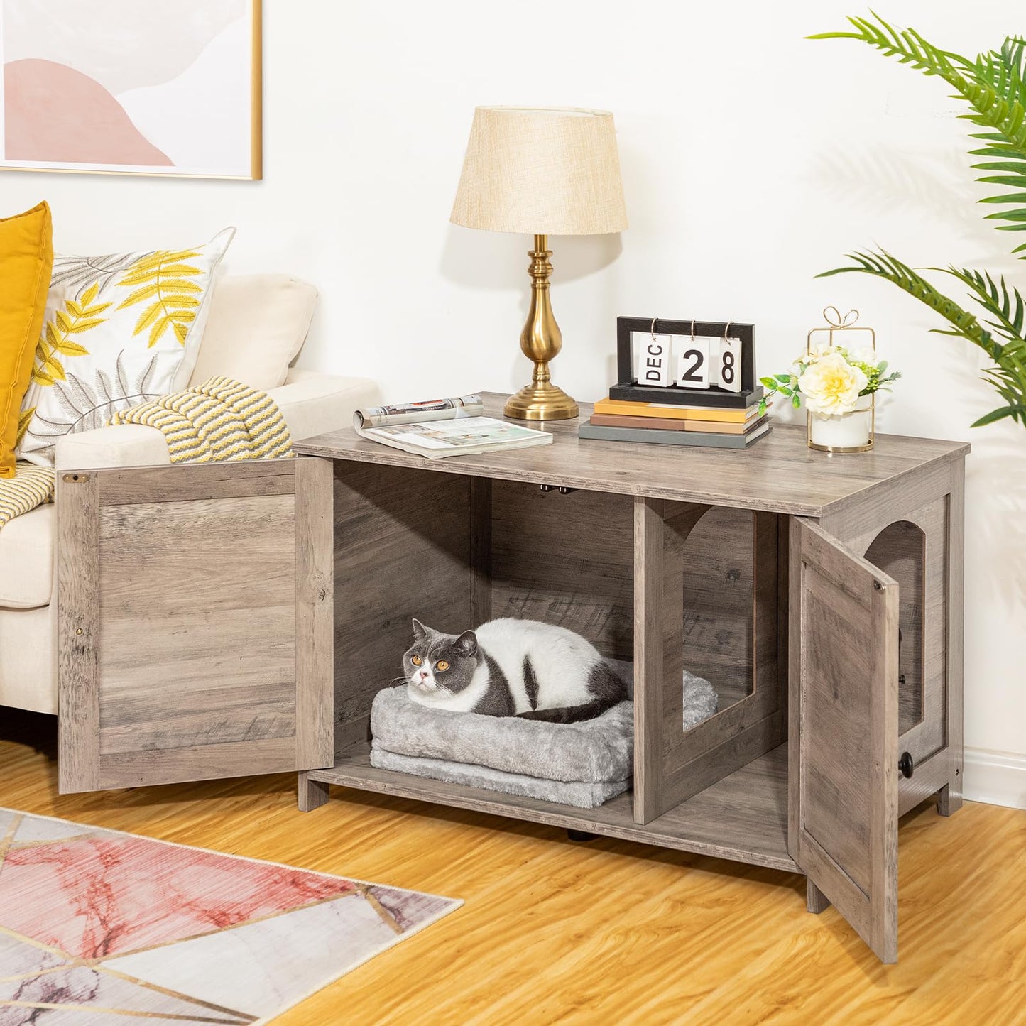 Wooden pet crate with a cat inside in a living room setting.