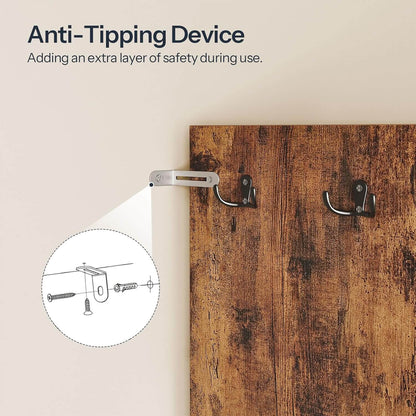 Anti-tipping device attached to a wooden surface with text explaining its safety feature.