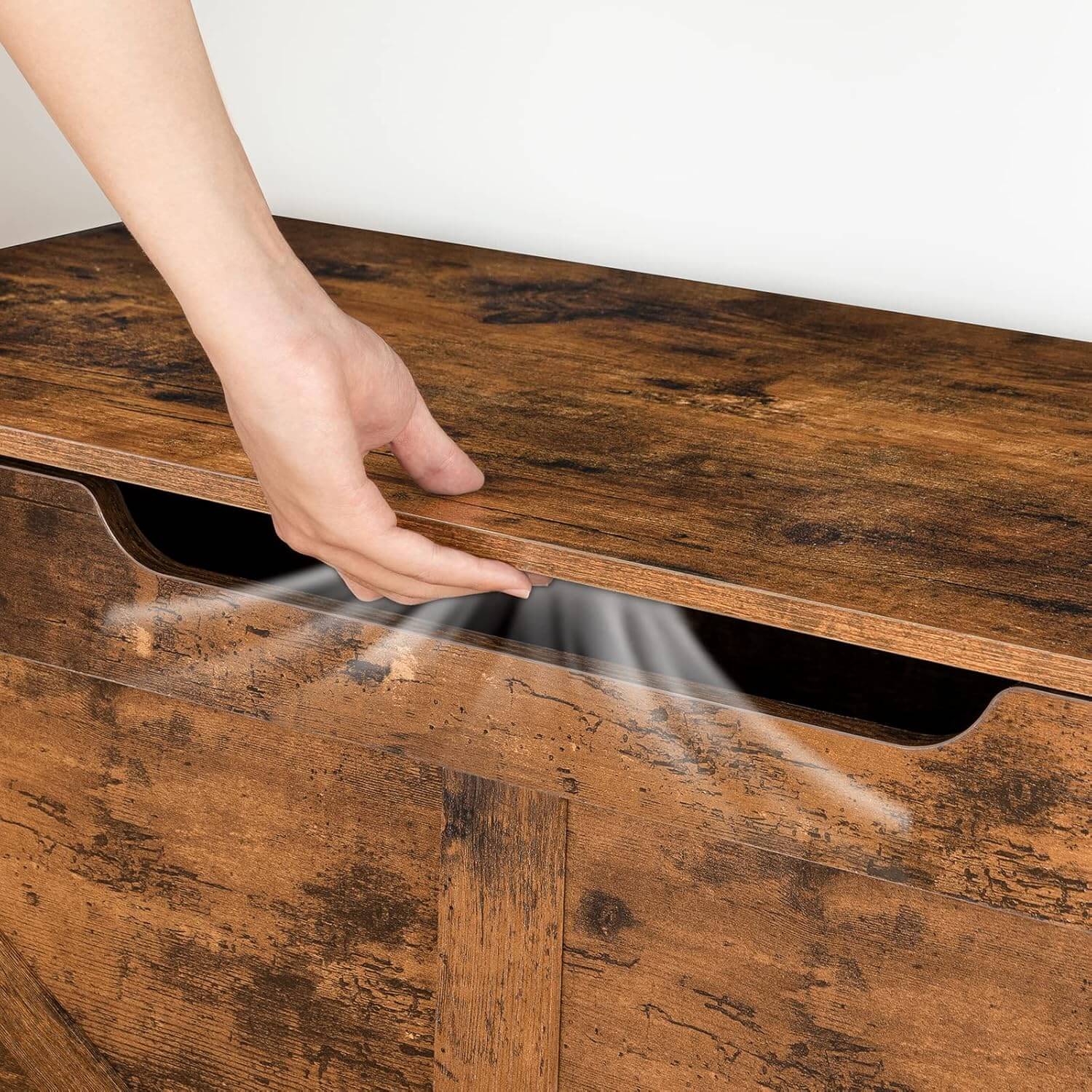 Hand opening a wooden drawer with a white background