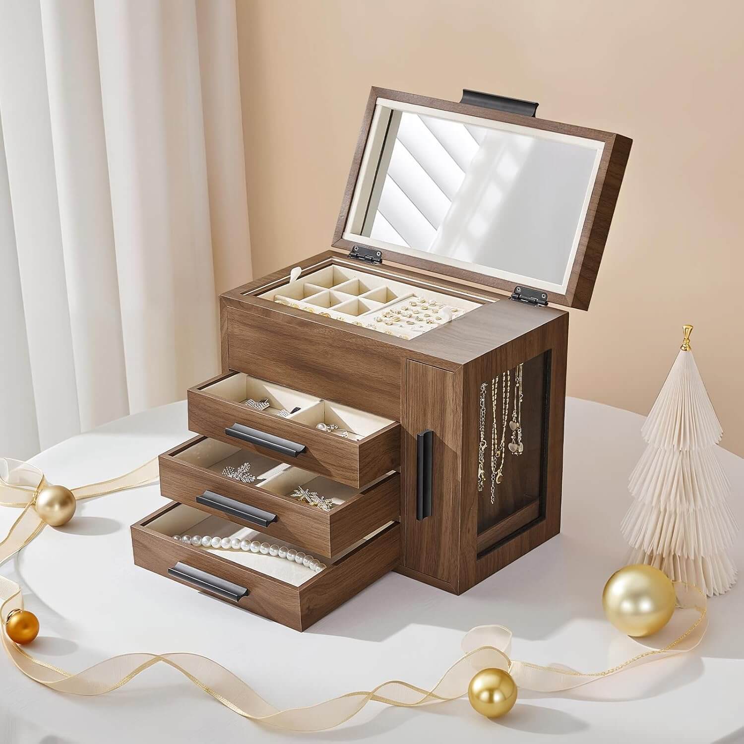 Wooden jewelry box with mirror lid on a white surface with decorative elements.