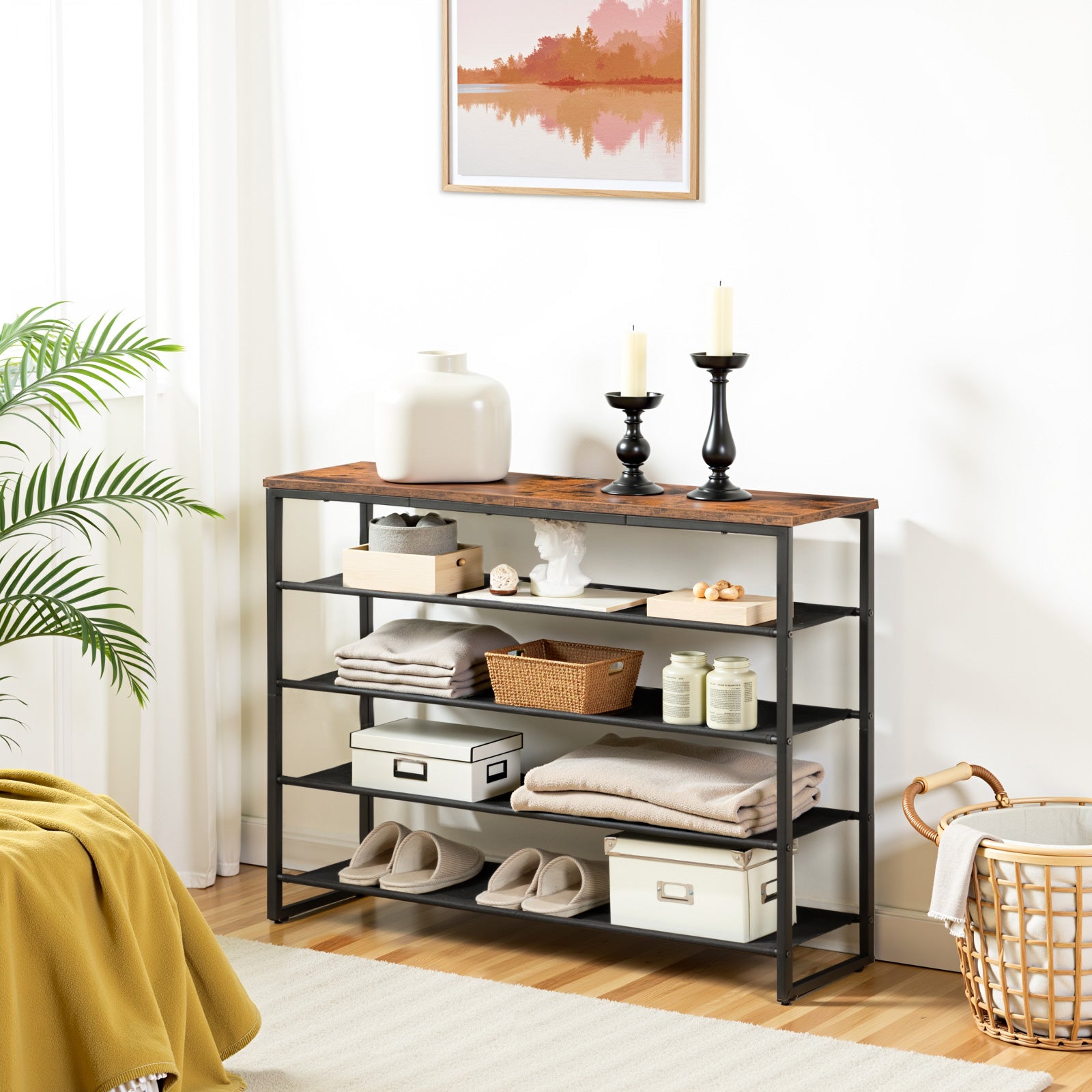 Industrial style accent console table used for shoe storage and decorative frames in a living room.
