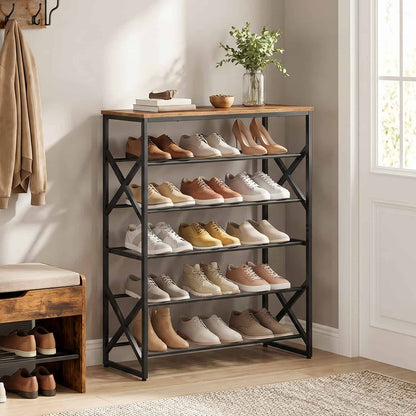 Large 5-tier industrial shoe rack organiser placed in a warm entryway filled with leather boots, sneakers, and a flower vase on top.