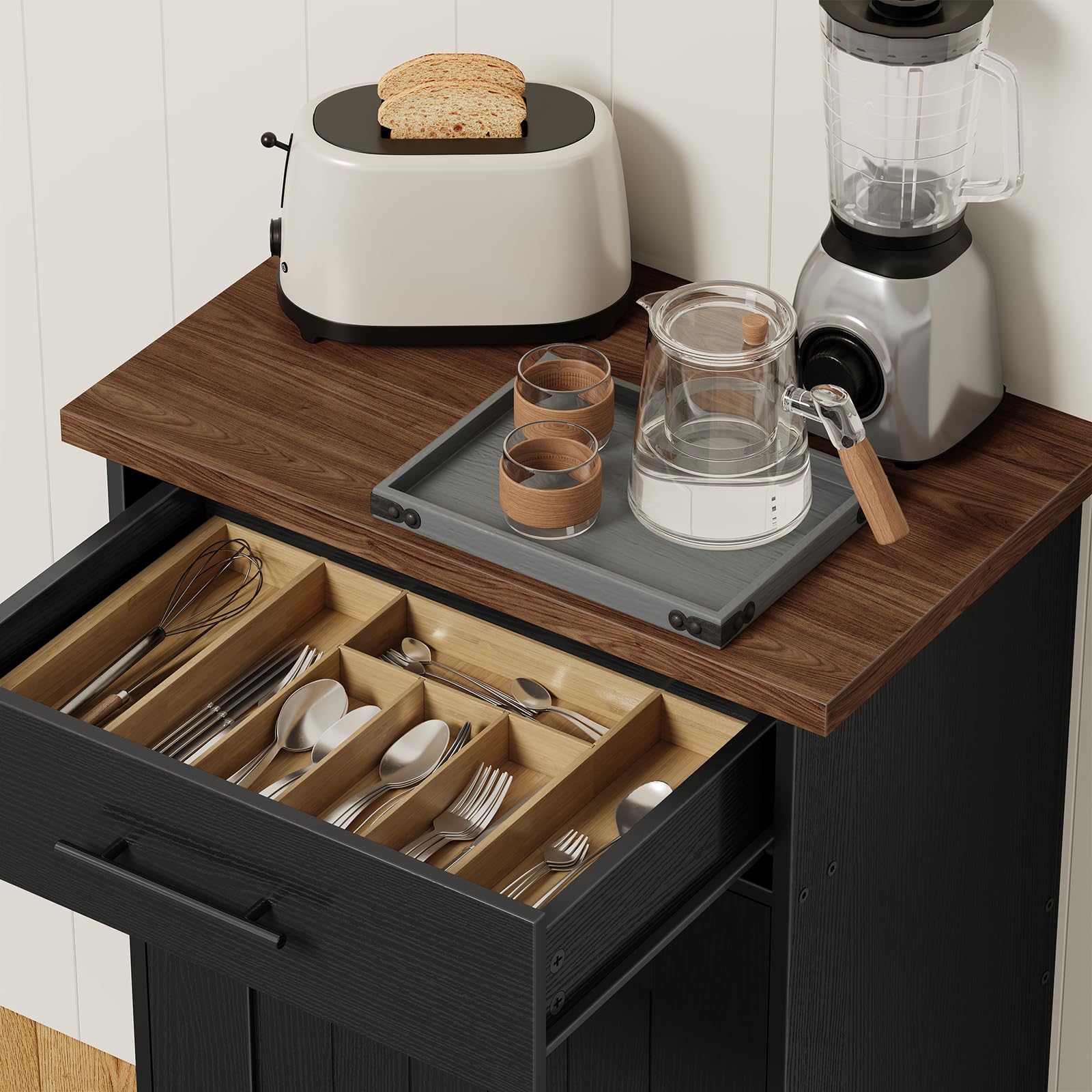 Top-down view of the pulled-open top drawer organized with a wooden cutlery tray holding forks and knives.