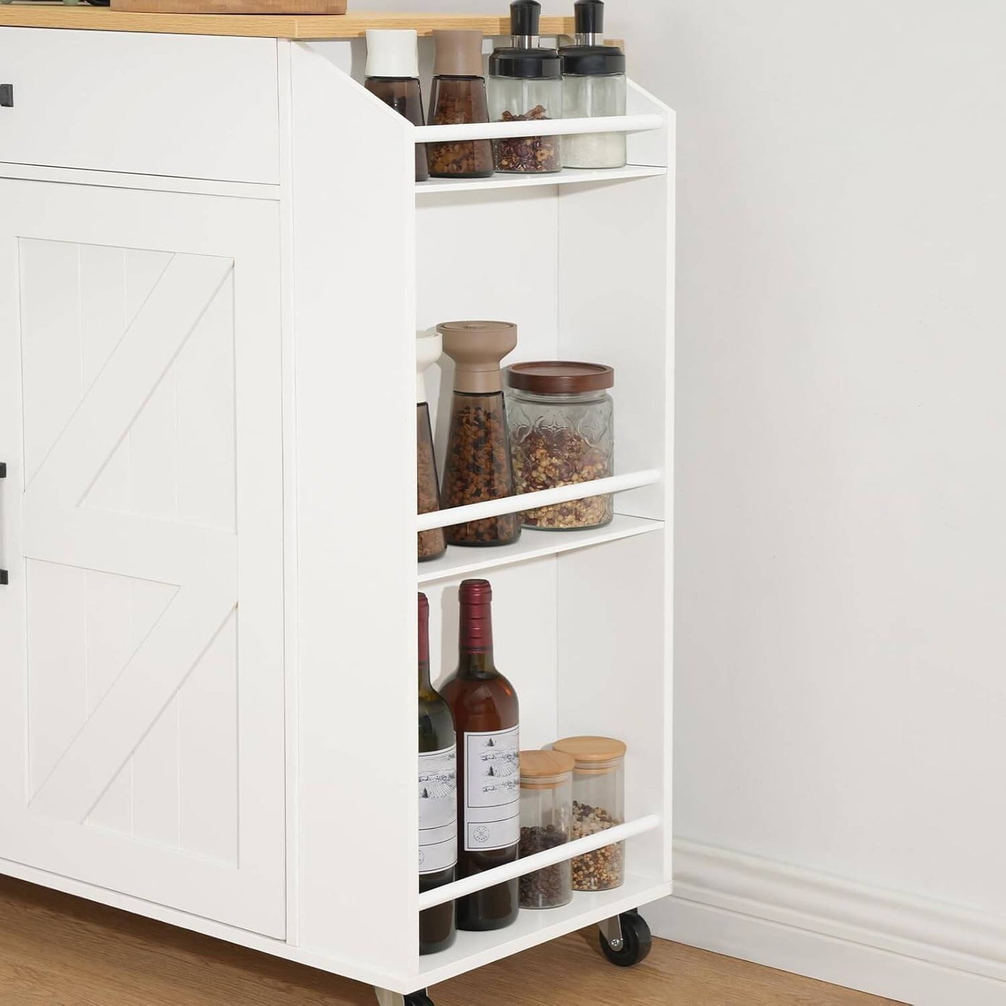 White kitchen cart with shelves filled with bottles and jars against a white wall.