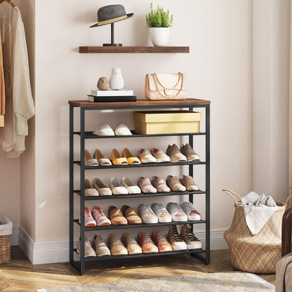 Large shoe storage rack setup in a bedroom corner acting as an entryway closet shelf