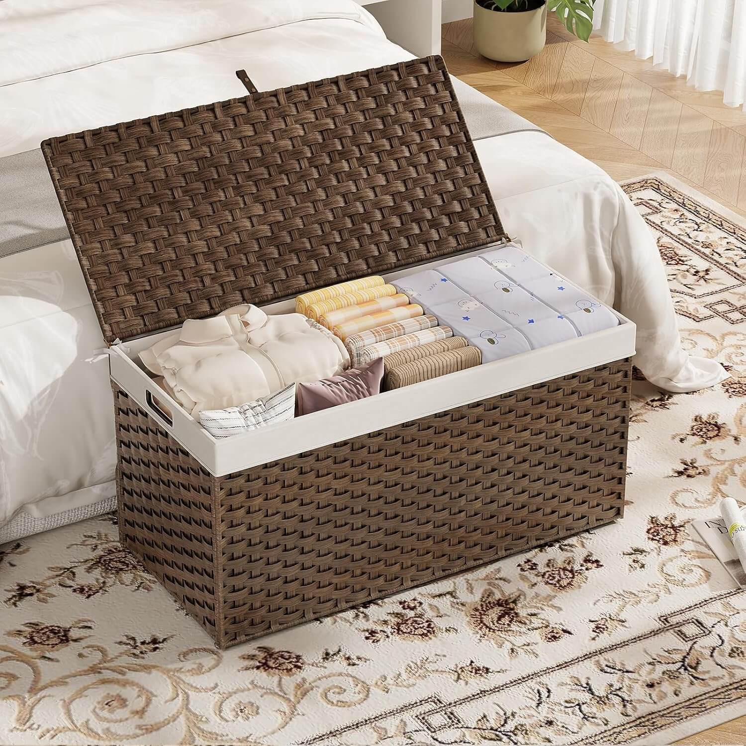 Woven storage basket with clothes on a bed in a bedroom