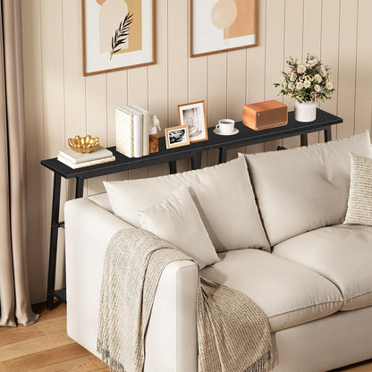 Two pieces of long skinny behind couch console shelves aligned together along a modern living room sectional sofa.