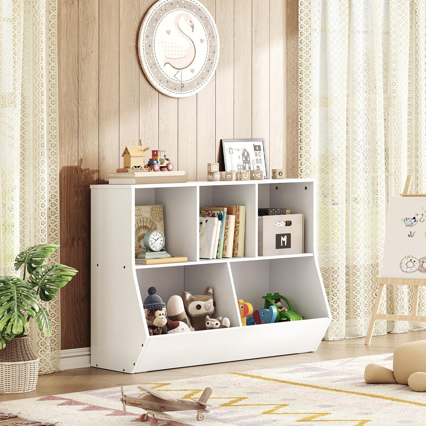 Low profile toddler bookcase holding stuffed teddy bears in a warm farmhouse style nursery room setting.