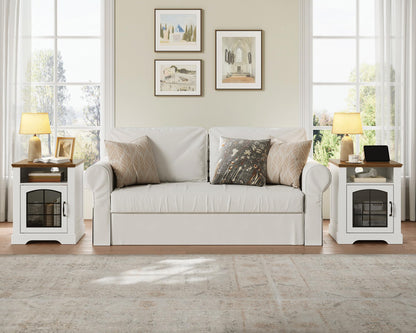 White sofa with decorative pillows in a living room setting with side tables and lamps.