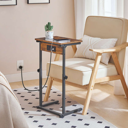Mobile C-shaped snack table placed next to a wooden armchair in a sunlit living room setup.
