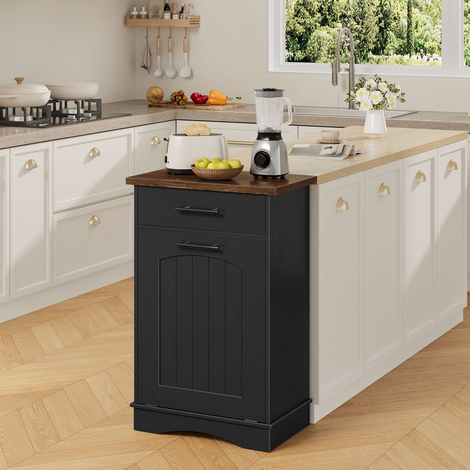 Black tilt-out cabinet placed at the end of a white kitchen island as an extra workspace and storage extension.