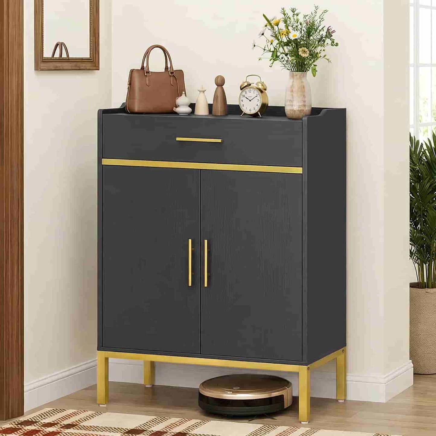  Modern black and gold shoe storage cabinet styled with a purse, vase, and clock in a hallway entryway.